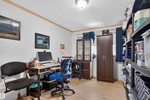 Wood-finish flooring with white wall finishes and wood-toned trim - 1405 53222 Range Road 272, Rural Parkland County, AB 