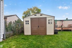 Utility shed with double doors, side windows, and a gabled roof - 