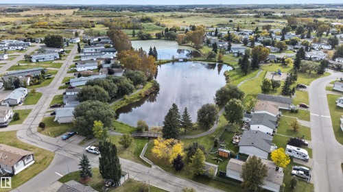 Lakeside community featuring residential properties, mature trees, and paved roads - 1405 53222 Range Road 272, Rural Parkland County, AB 