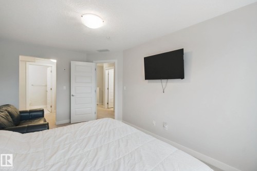 Recessed ceiling light, paneled interior door, and light-toned wall paint - #125 5151 Windermere Bv Sw Sw, Edmonton, AB 