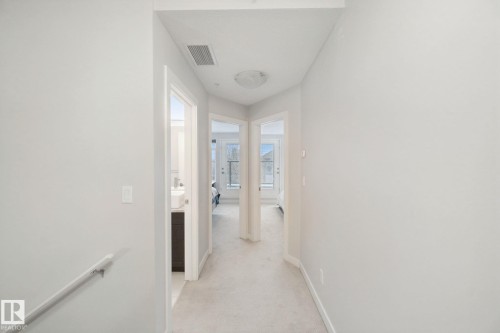 Neutral-toned walls with carpeted flooring, featuring a flush-mount ceiling light - #125 5151 Windermere Bv Sw Sw, Edmonton, AB 