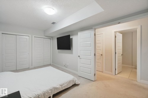 Recessed lighting, light-colored carpeting, multiple paneled closet doors, and additional doorway access - #125 5151 Windermere Bv Sw Sw, Edmonton, AB 