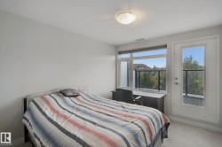 Recessed lighting, large window, glass panel balcony railing, and a private exterior door - 