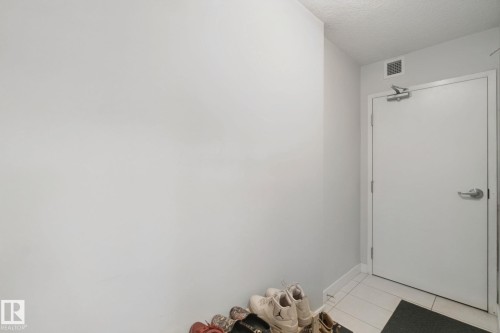 White painted walls, textured ceiling, tile flooring - #125 5151 Windermere Bv Sw Sw, Edmonton, AB 
