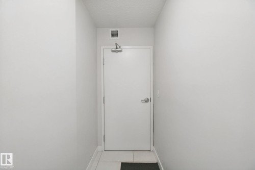 White interior door with metal hardware and overhead vent - #125 5151 Windermere Bv Sw Sw, Edmonton, AB 