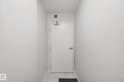 White interior door with metal hardware and overhead vent - 
