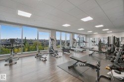 Integrated fitness center featuring extensive window-line, wood-finish flooring, recessed lighting, and wall-mounted mirrors - 