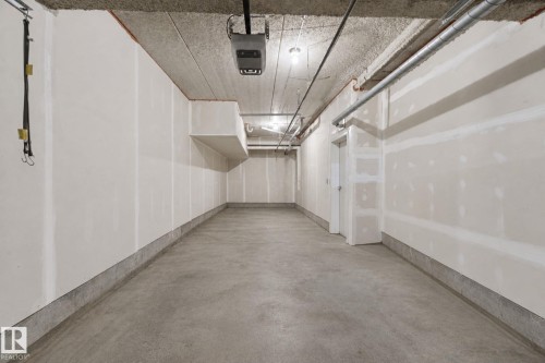 Concrete flooring with a concrete perimeter, unfinished drywall, and exposed ceiling - #125 5151 Windermere Bv Sw Sw, Edmonton, AB 