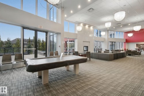 Expansive room with high ceilings, recessed lighting, and large windows - #125 5151 Windermere Bv Sw Sw, Edmonton, AB 