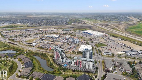 Aerial perspective showcasing urban development, residential areas, commercial properties, and visible infrastructure - #125 5151 Windermere Bv Sw Sw, Edmonton, AB 