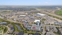 Aerial perspective showcasing urban development, residential areas, commercial properties, and visible infrastructure - 