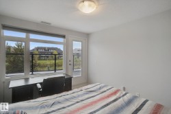 White walls featuring a large multi-pane window and an exterior door with a glass panel - 