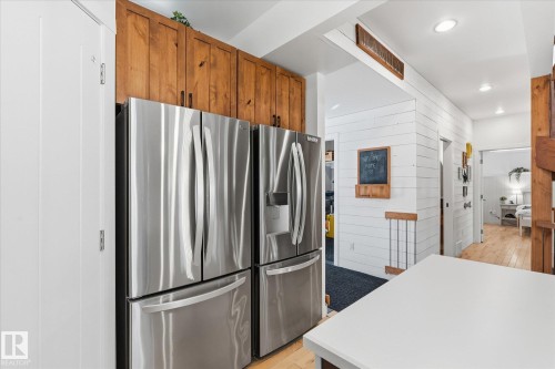 Stainless steel appliances, wood-finish cabinetry, white shiplap wall paneling, recessed lighting, and light wood-finish flooring - #45 53122 Rge Road 14, Rural Parkland County, AB 