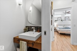 Floating wood-finish vanity with a rectangular vessel sink and wall-mounted faucet, complemented by a unique mirror - 