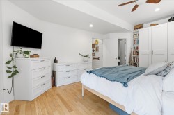 Hardwood-style flooring, recessed lighting, ceiling fan, and built-in shelving - 