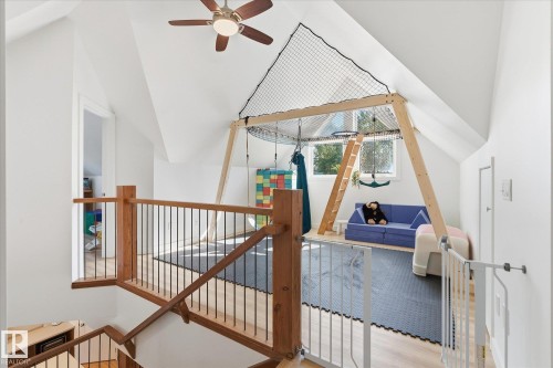 Vaulted ceilings with a ceiling fan, hardwood flooring, and an open wood and metal railing - #45 53122 Rge Road 14, Rural Parkland County, AB 