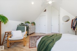 Vaulted ceiling with ceiling fan, recessed lighting, wood-finish flooring, and white paneled doors - 