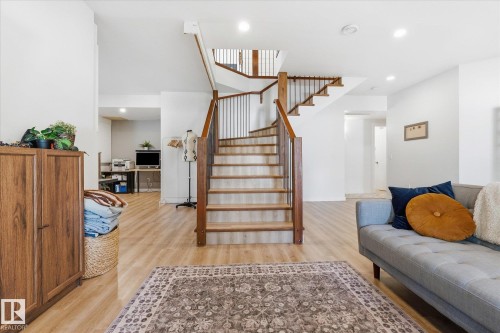 Wood-finish flooring throughout, featuring a multi-level staircase with wood treads and metal balusters - #45 53122 Rge Road 14, Rural Parkland County, AB 