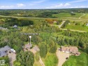 Expansive property featuring a treed landscape, a multi-lane highway, and open fields in the background - #45 53122 Rge Road 14, Rural Parkland County, AB 