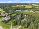 Expansive residential property with mature trees, a private pool, and a structured driveway, surrounded by a natural landscape - #45 53122 Rge Road 14, Rural Parkland County, AB 