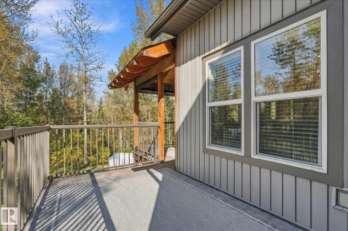 Exterior deck with metal railings and a wood-beamed covered section - #45 53122 Rge Road 14, Rural Parkland County, AB 