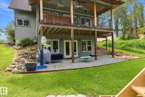 Exterior featuring a multi-level deck, lower patio area, and gravel landscaping - #45 53122 Rge Road 14, Rural Parkland County, AB 