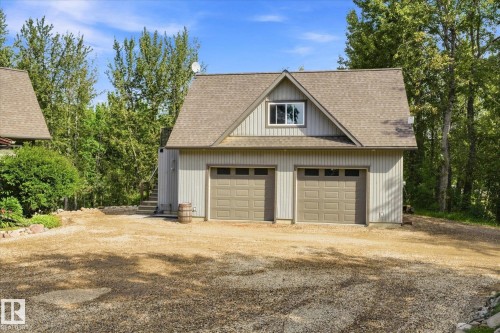 Two-car garage with panel doors, upper-level dormer window, and exterior stairs - #45 53122 Rge Road 14, Rural Parkland County, AB 