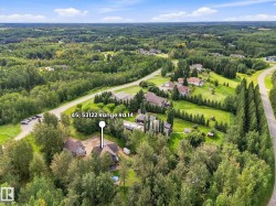 Expansive property with a verdant landscape, surrounded by mature trees - 