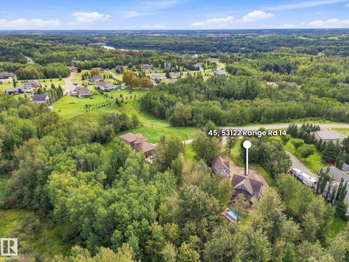 Expansive treed lot featuring a private residence with a dark-toned exterior and a blue above-ground pool - #45 53122 Rge Road 14, Rural Parkland County, AB 