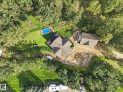 Property with a multi-gabled roofline, an additional structure, and an above-ground pool - 