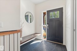 Solid entry door with glass paneling, full-length sidelight, wood-finish built-in bench, and shiplap wall accent - 