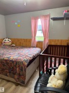 Wood-finish flooring with a neutral wall color and wood-look paneling - 