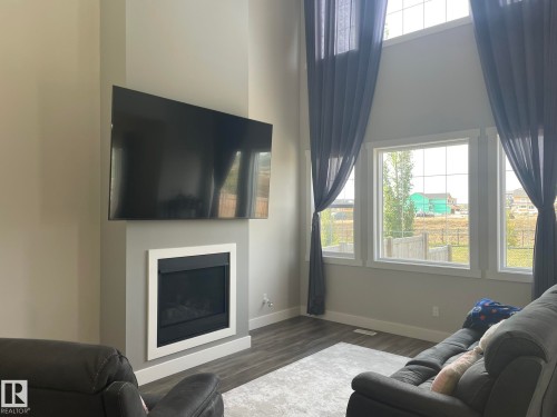 Integrated fireplace feature with white surround - 7939 Erasmus Crescent Nw, Edmonton, AB 