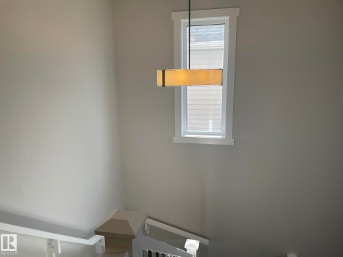 Rectangular pendant light fixture, white window trim, and painted walls - 7939 Erasmus Crescent Nw, Edmonton, AB 