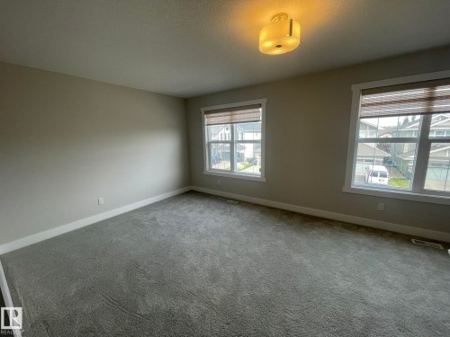 Plush gray carpeting with two large windows - 7939 Erasmus Crescent Nw, Edmonton, AB 