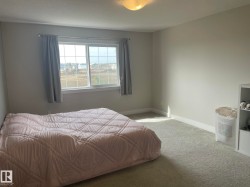 Neutral wall finishes, recessed window, carpeted flooring, and a flush mount ceiling fixture - 