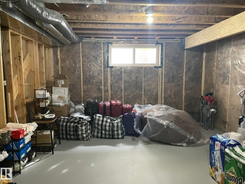 Unfinished lower level with wood framing, exposed ductwork, and a single window - 7939 Erasmus Crescent Nw, Edmonton, AB 