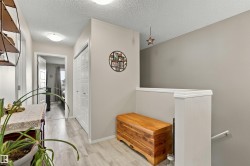 Hallway featuring wood-finish flooring, two panel-style doors, and recessed ceiling lighting - 