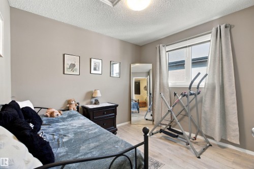 Light gray interior paint and wood-finish flooring - 38 Red Tail Way, St. Albert, AB 