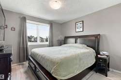 Spacious room featuring light gray walls, a large window, light wood-finish flooring, and a flush mount ceiling light - 