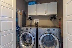 Laundry area with built-in cabinetry, overhead hanging rod, and two-panel interior doors - 