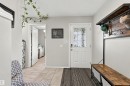 Entryway featuring a white paneled door with decorative glass, light grey wall paint, and tile flooring - 38 Red Tail Way, St. Albert, AB 