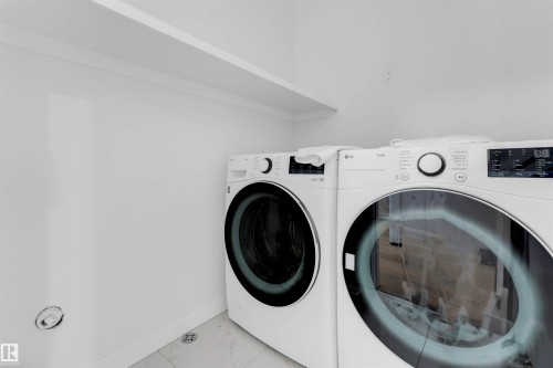 Laundry area with an overhead storage shelf and white wall finish - 403 Pine Point, Leduc, AB 