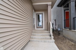 Entry with concrete steps, a full-lite door, and a covered porch - 
