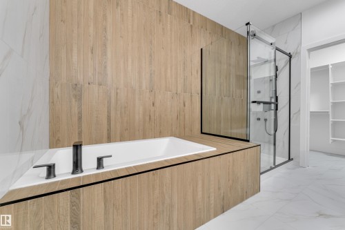 Built-in soaking tub with matte black fixtures - 794 Bank Drive, Leduc, AB 