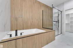 Built-in soaking tub with matte black fixtures - 