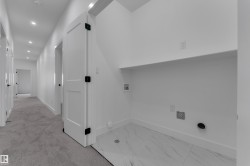 Laundry area featuring white tile flooring, a built-in shelf, and recessed lighting - 