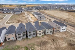 Developing suburban neighborhood with multiple residential properties and infrastructure - 