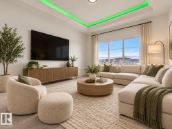 Tray ceiling with accent lighting, large multi-pane window, entertainment console, wall-mounted television, and recessed lighting - 