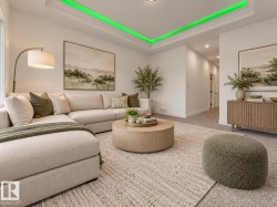 Tray ceiling with integrated lighting, recessed lighting, and large windows - 